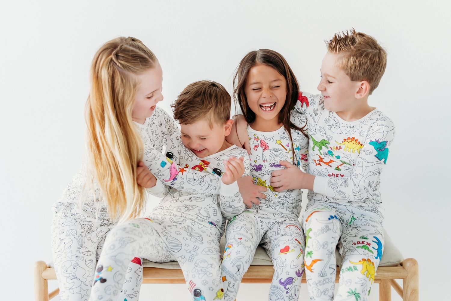 kids wearing coloring pajamas and laughing