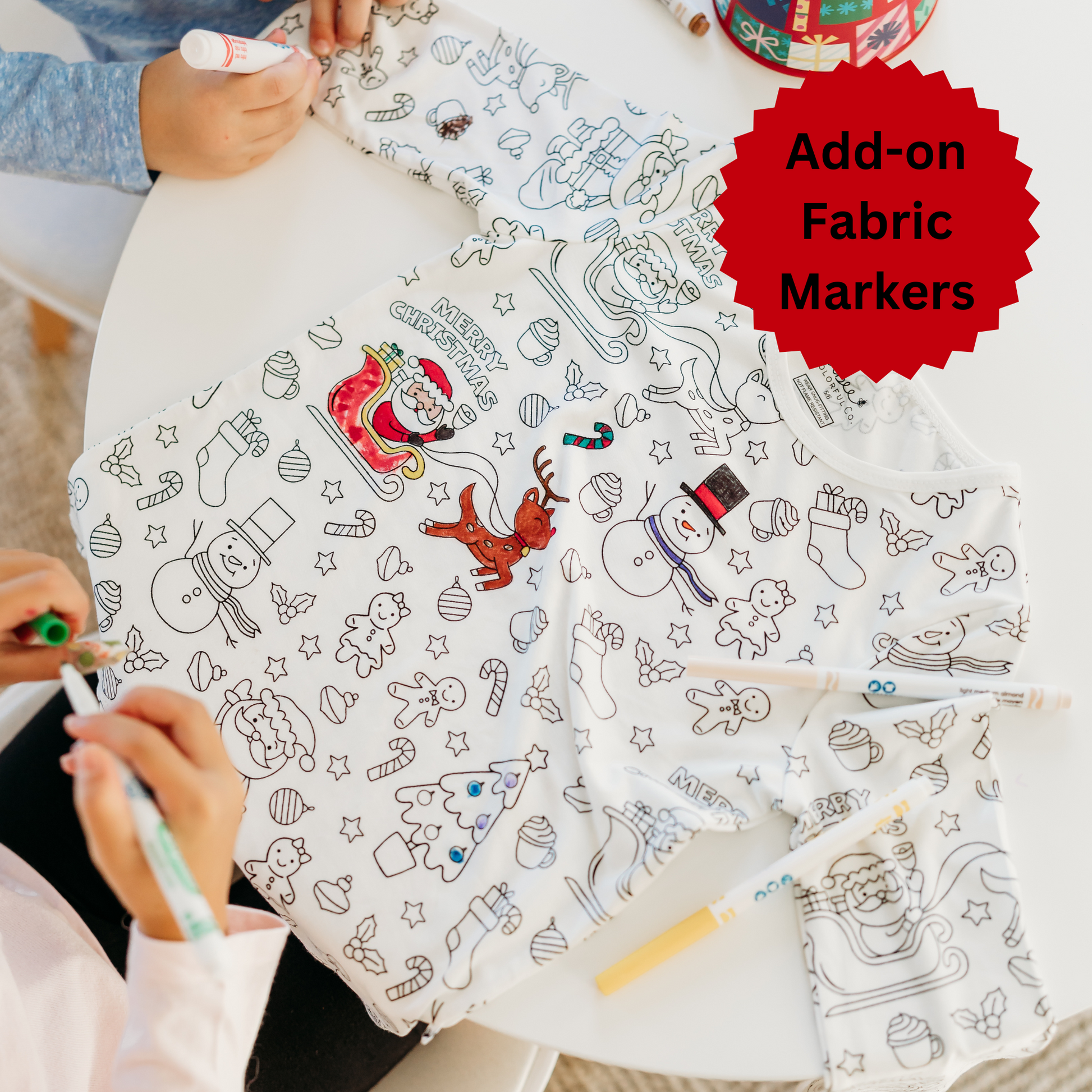 Kids coloring Christmas pajamas with fabric markers.