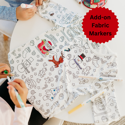Kids coloring Christmas pajamas with fabric markers.
