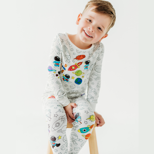 kid wearing space coloring pajamas made from soft bamboo