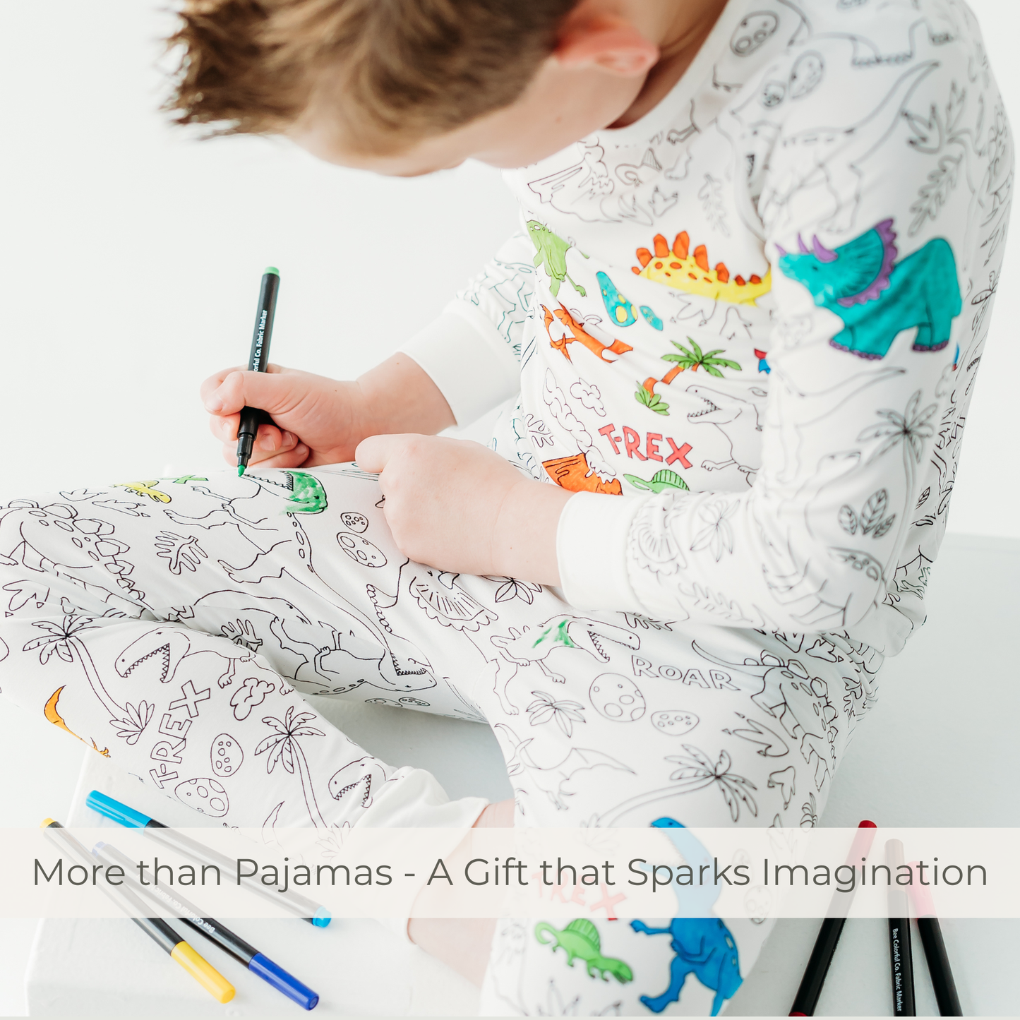Kid coloring dinosaur bamboo pajamas with fabric markers