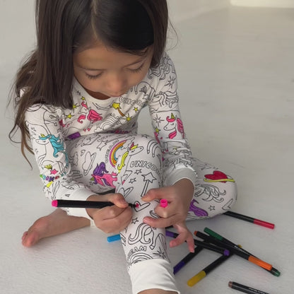 Kids coloring bamboo pajamas with fabric markers, unicorn print